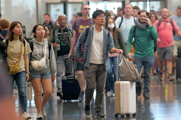 A group of people walking with luggage at Salt Lake City International Airport on July 3, 2024.
