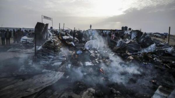 Palestinians look at the destruction after an Israeli strike where displaced people were staying in Rafah, Gaza Strip, Monday, May 27, 2024. Palestinians look at the destruction after an Israeli strike where displaced people were staying in Rafah, Gaza Strip, Monday, May 27, 2024.